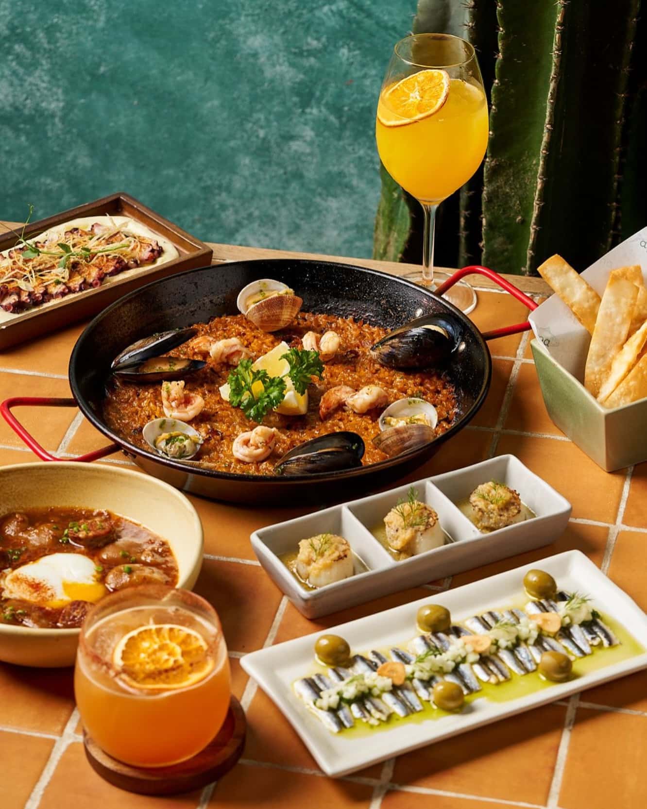 Seafood paella served in a pan with sides