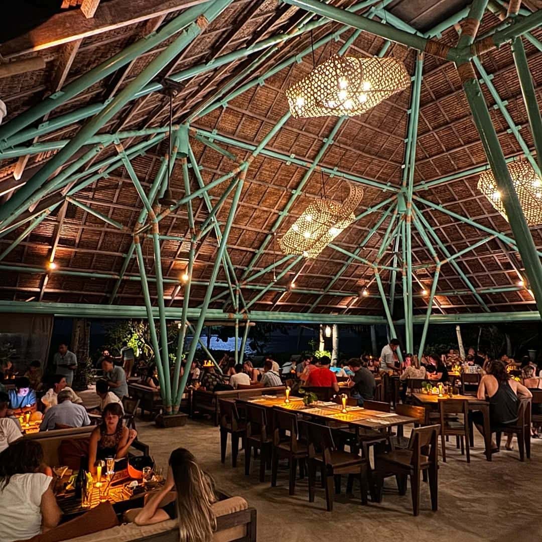Diners under a domed bamboo roof