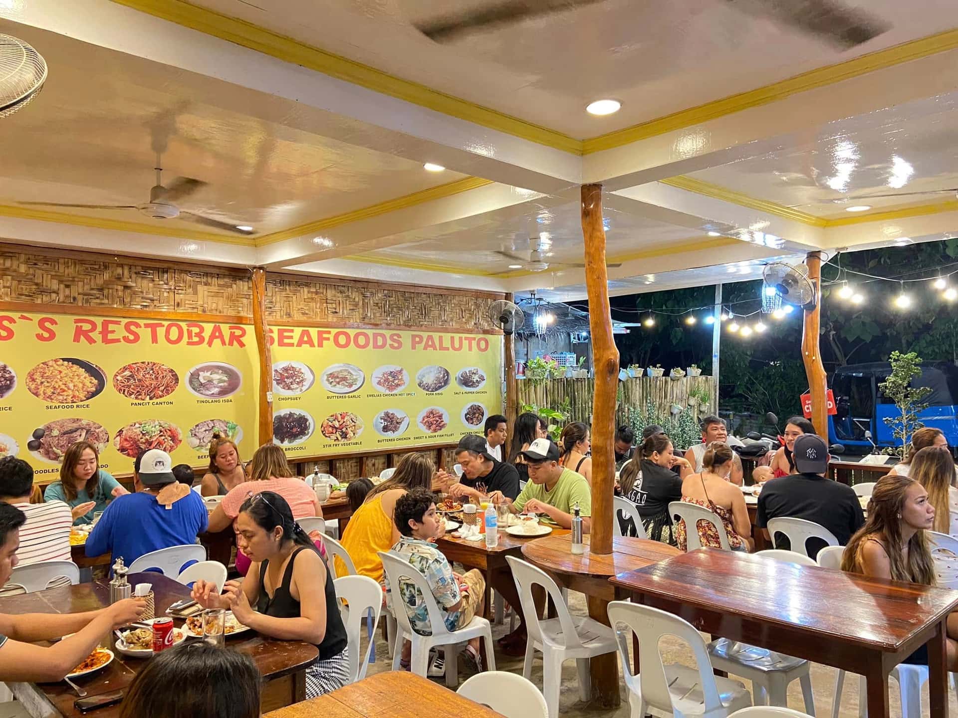 Diners inside a brightly lit seafood restaurant