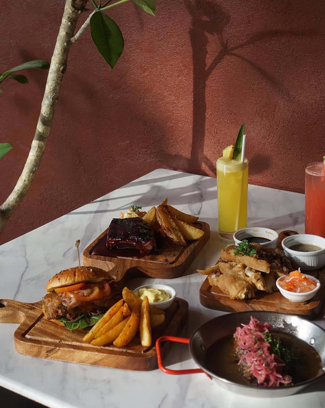 Cocktail and small plates on a stone table