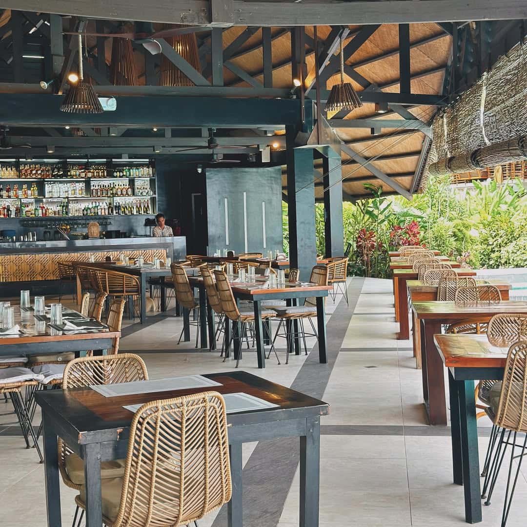Restaurant interior with rattan chairs and a bar