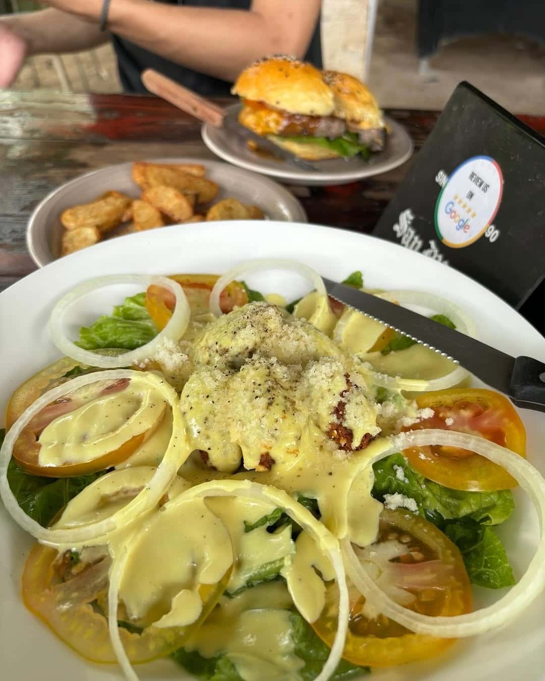 Creamy pasta topped with onion rings and herbs