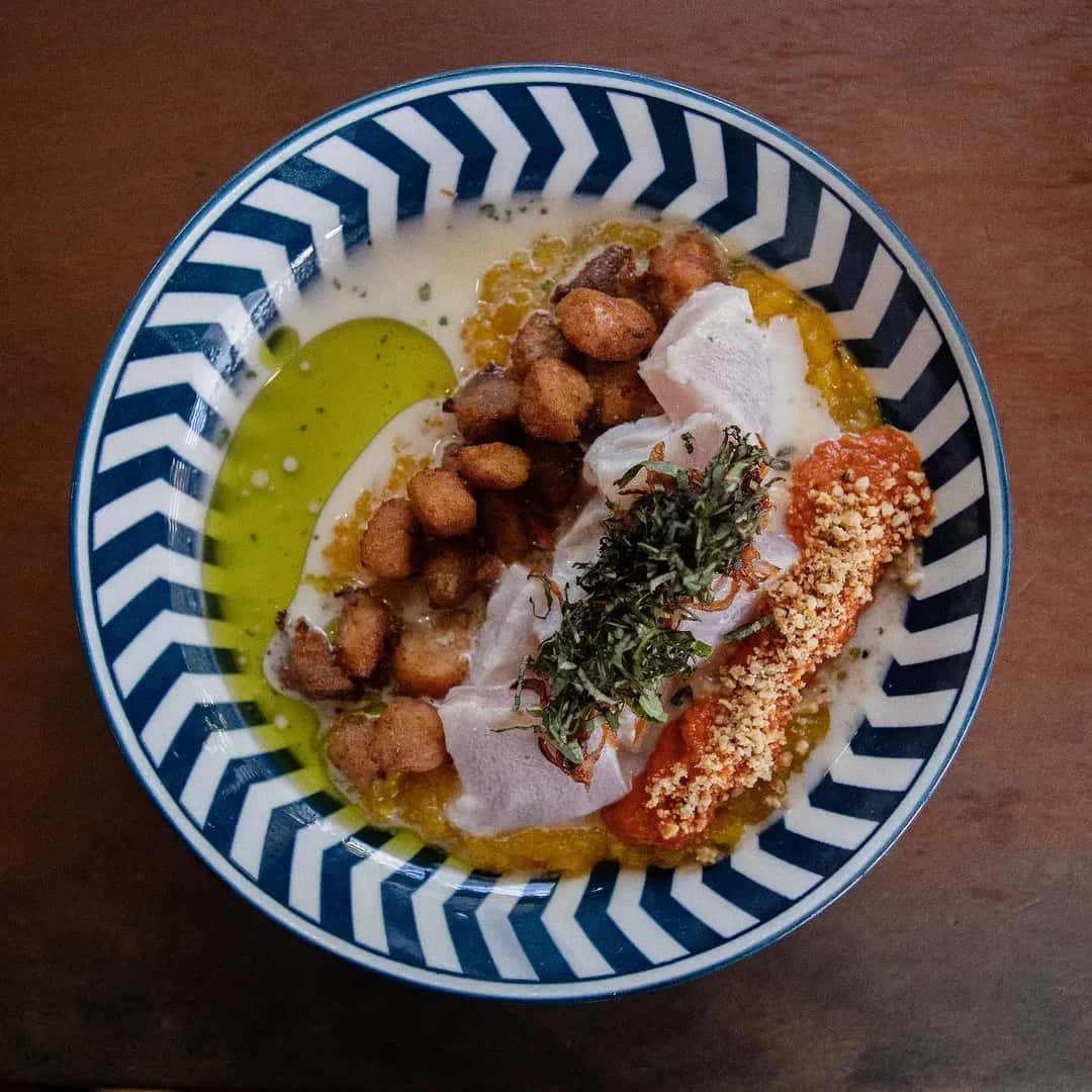 Ceviche with herbs and corn on a striped plate