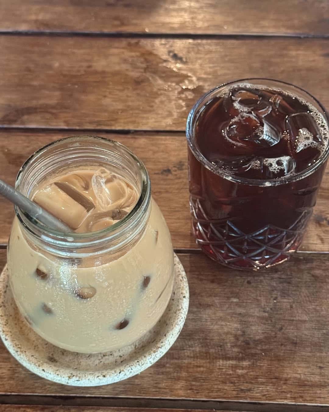 Iced latte beside an iced black coffee