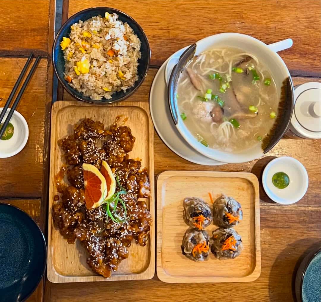 Shared table of lemon chicken, soup and siomai