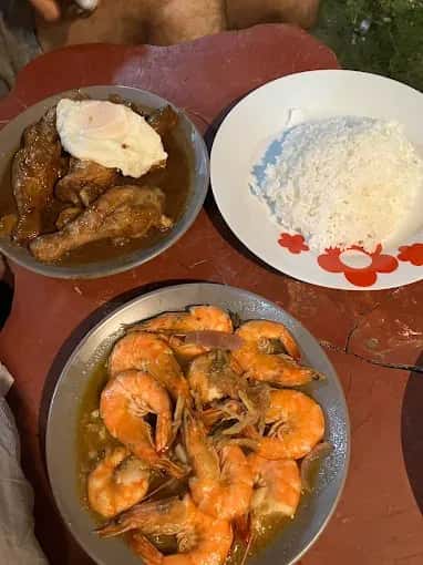 Fried chicken pieces beside a plate of rice