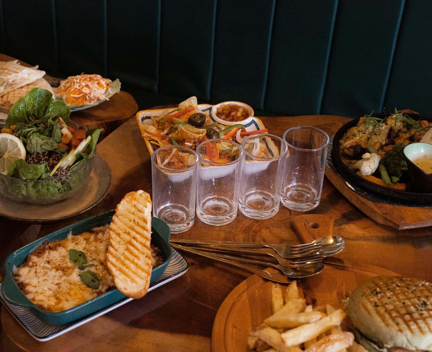 Table of shared dishes with empty glasses