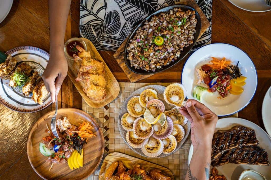 Overhead view of a shared table of plates and side dishes