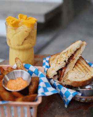 Toasted sandwich with a mango smoothie