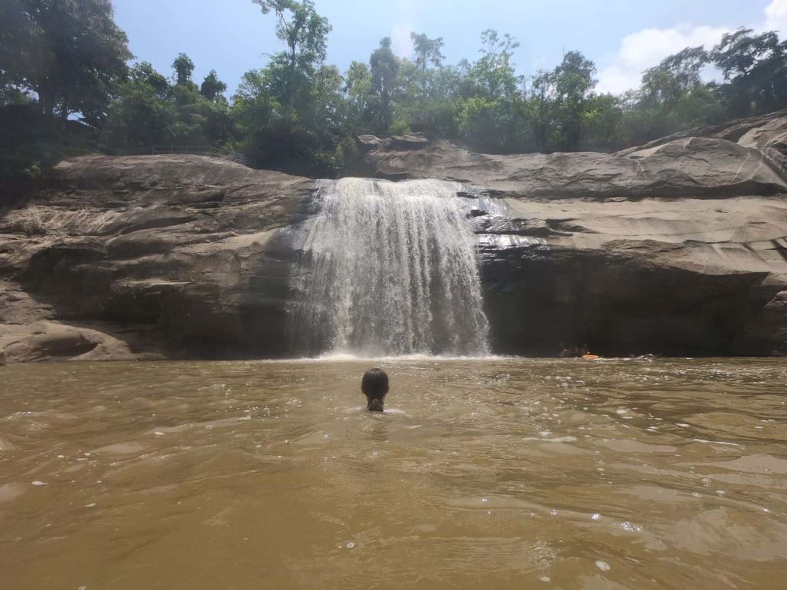 Swimmer in the pool below Tangadan Falls, San Gabriel, La Union