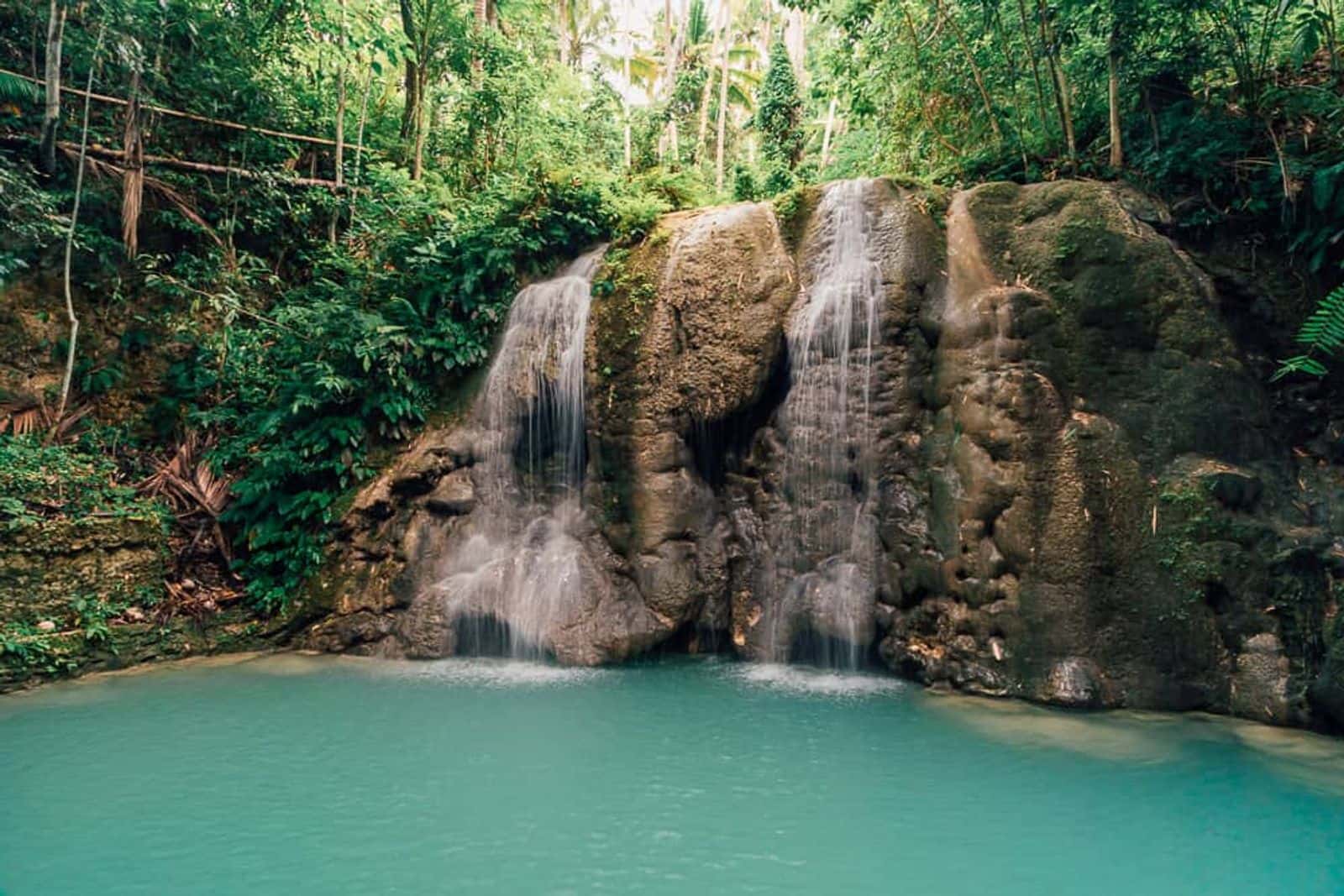 Lugnason Falls twin cascades and blue pool, San Juan, Siquijor