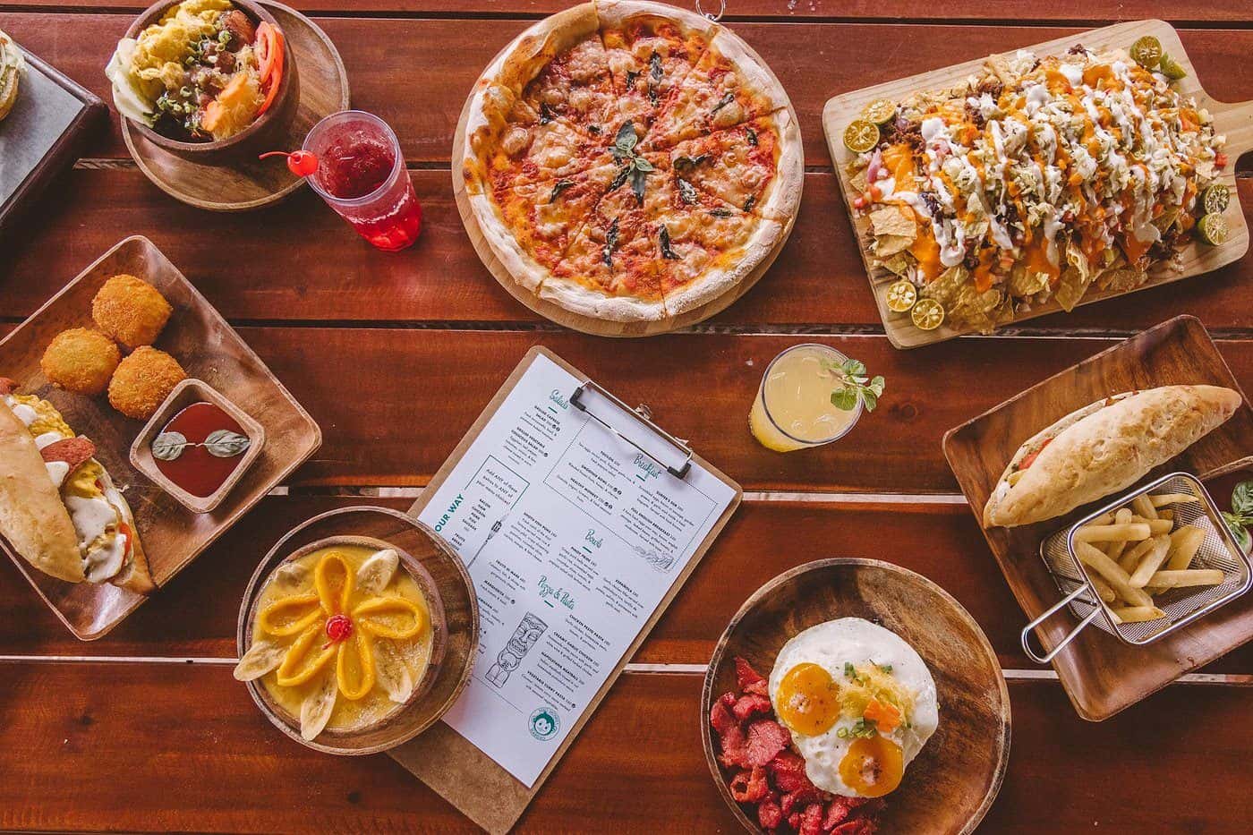 Overhead spread of pizza, bowls and small plates