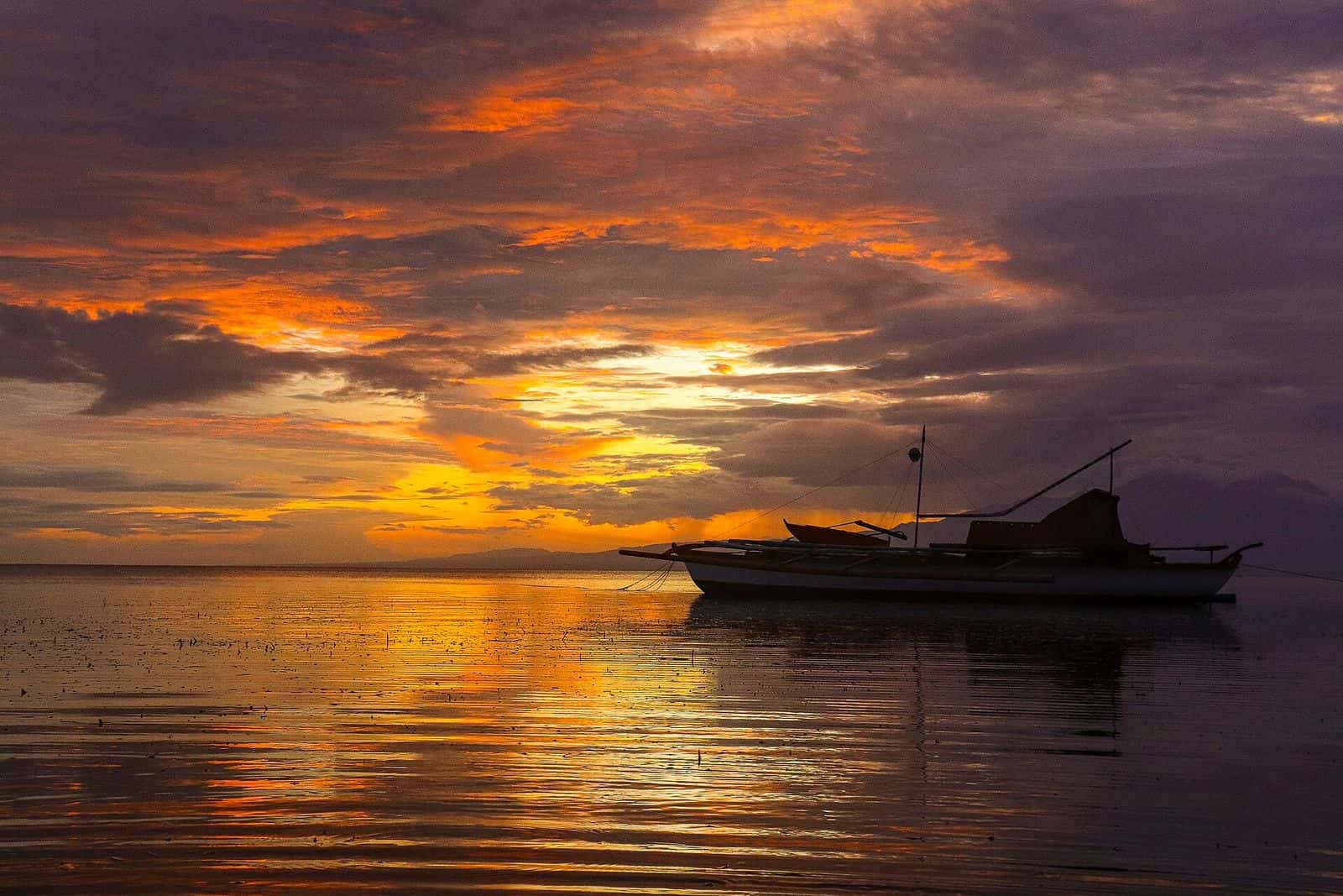 Boat at sunset off Tubod, San Juan, Siquijor