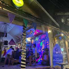 Colourful mural and neon signage at Strum Siargao