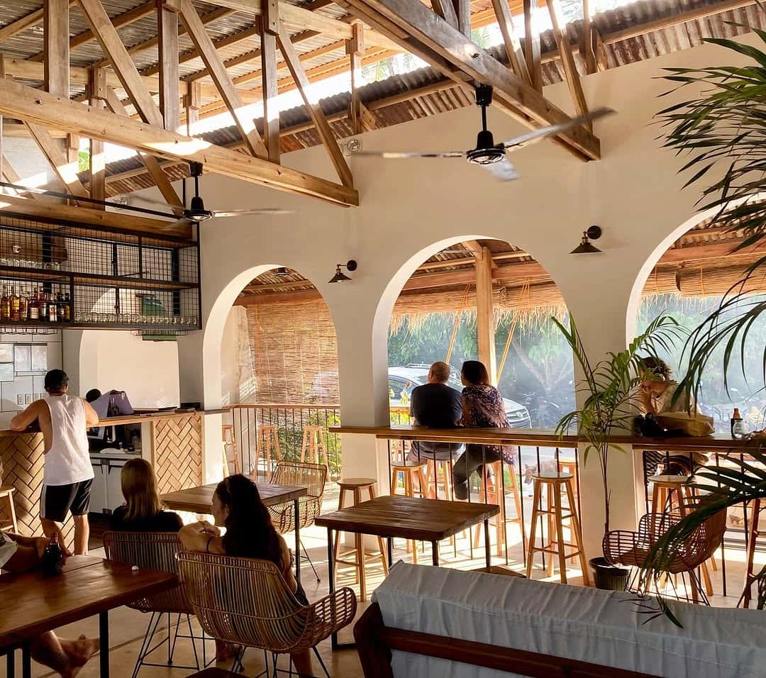 Cafe with arched windows, bar seating and plants