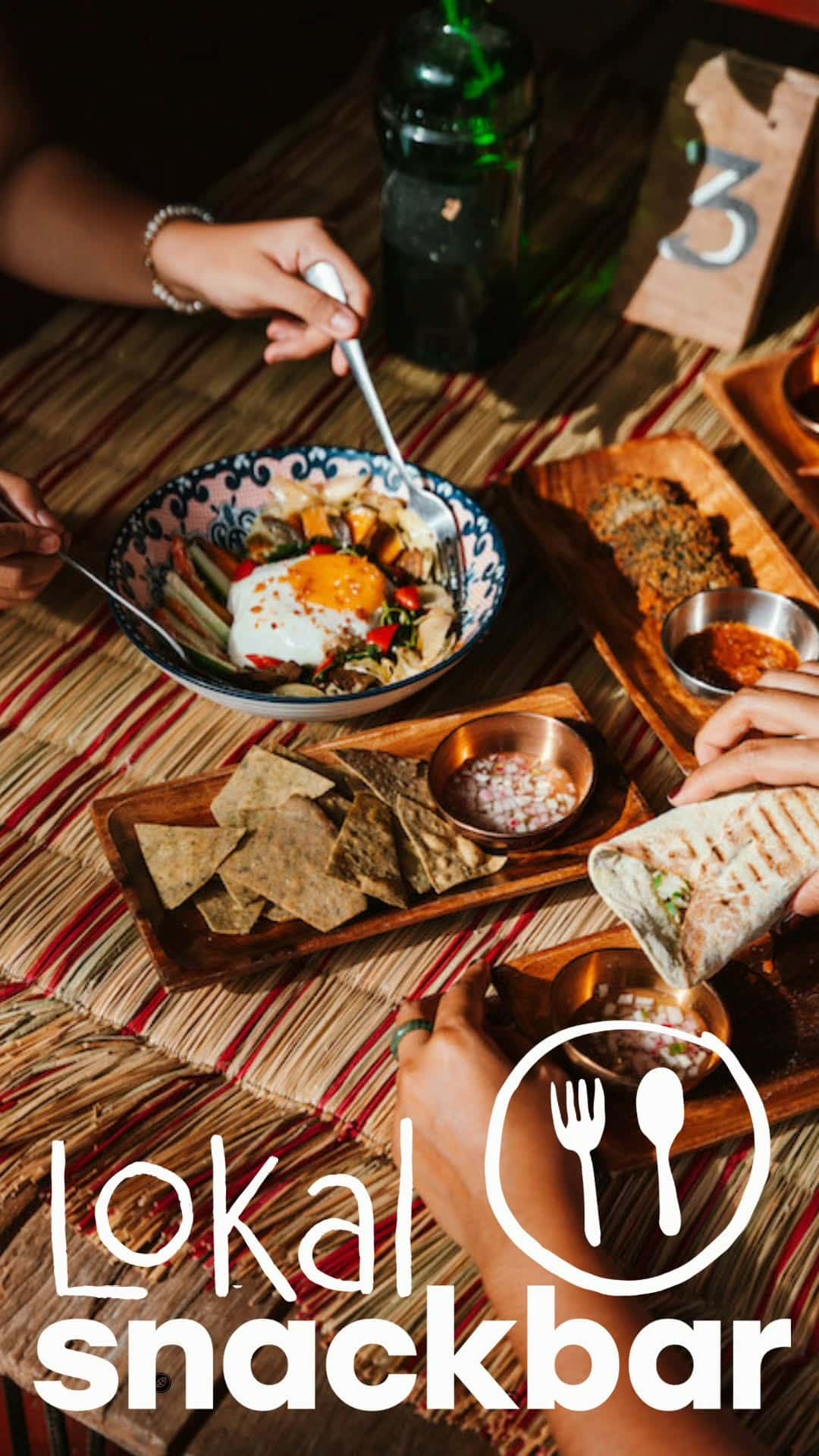 Filipino breakfast of egg, rice and dips on a woven mat