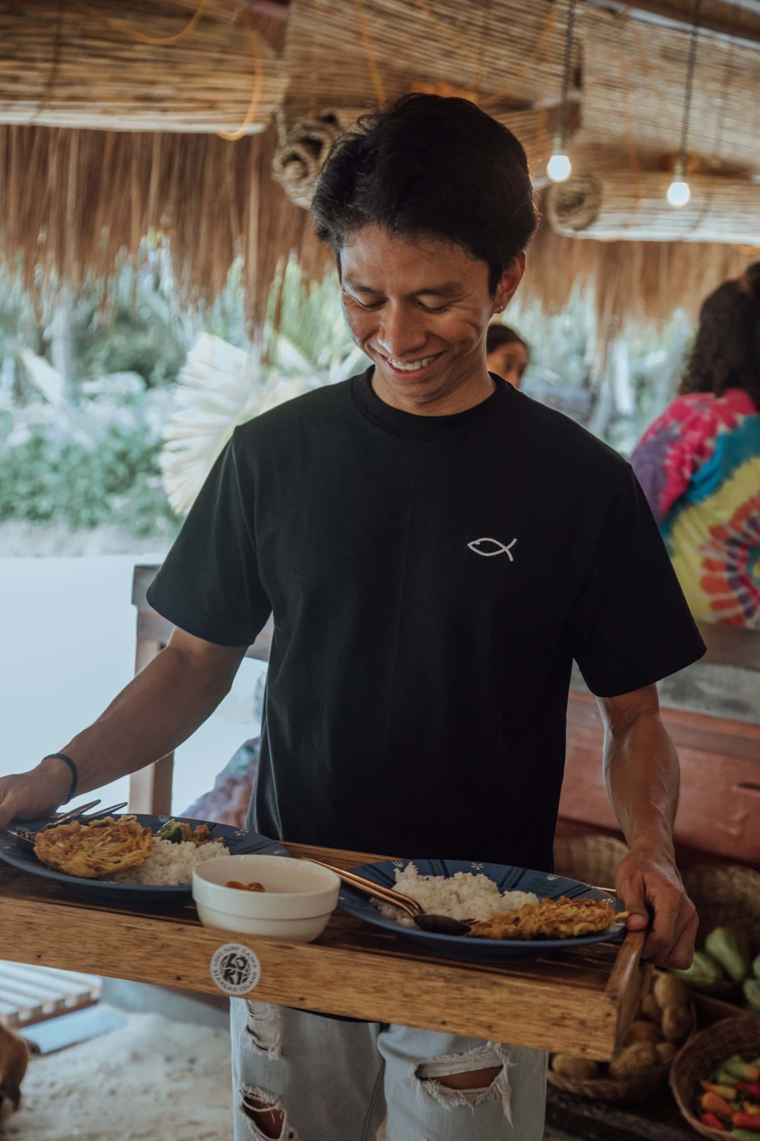 Man in a black t shirt with a small fish logo