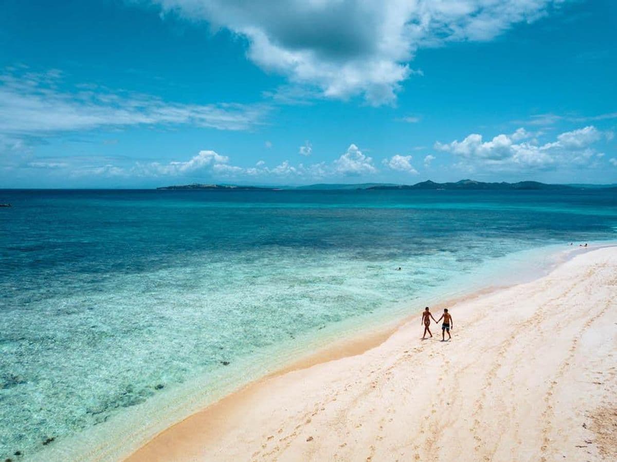 Couple on the bare sandbar of Naked Island, Siargao