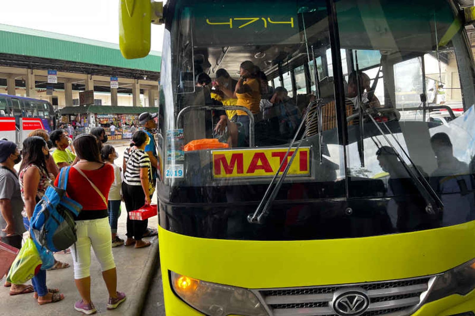 Passengers boarding a bus to Mati