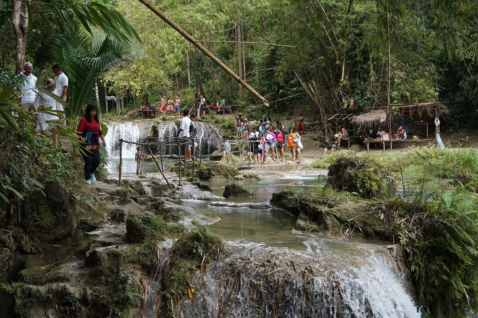 Visitors and bamboo huts around the upper pools at Cambugahay Falls