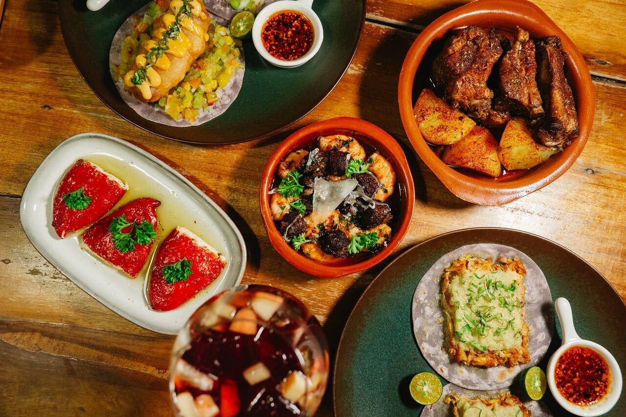 A shared table of small plates at a Siargao restaurant, the kind booked out on Christmas Eve