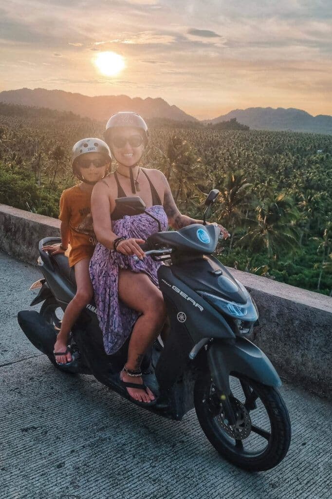 Parent and kids on a scooter ride in Siargao