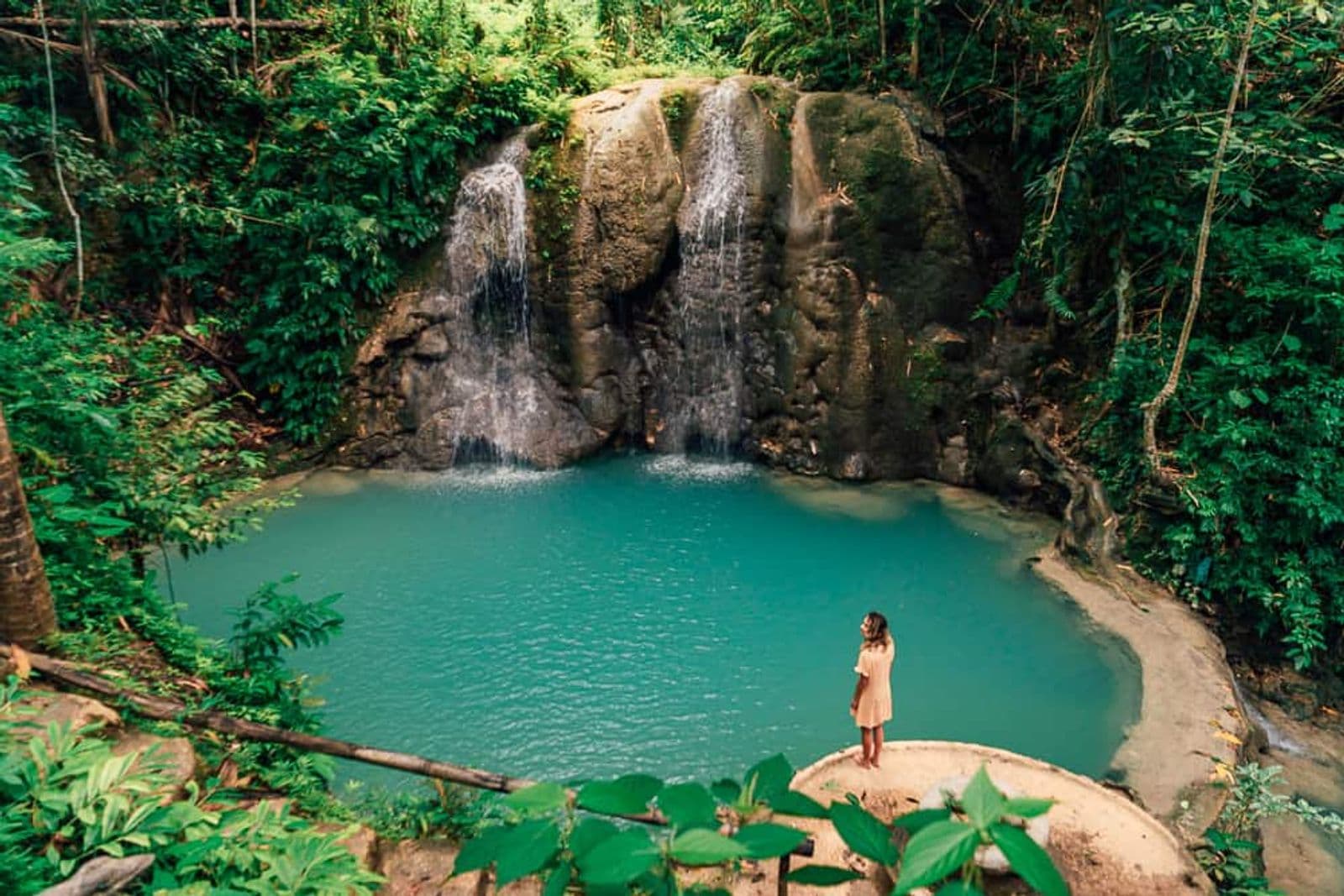Wide view of the pool at Lugnason Falls with a visitor on the rocks