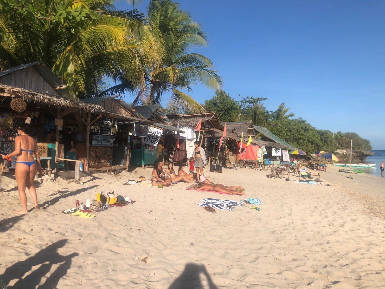 Beach shacks and sunbathers on Paliton Beach