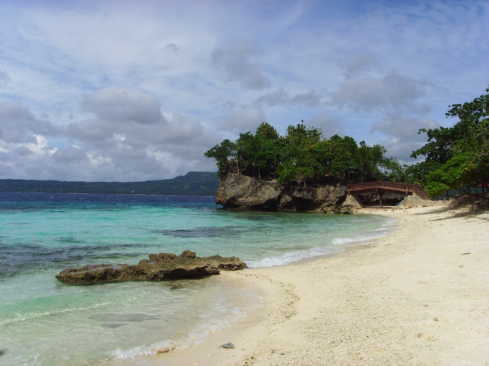 Rocky islet and white sand at Salagdoong Beach