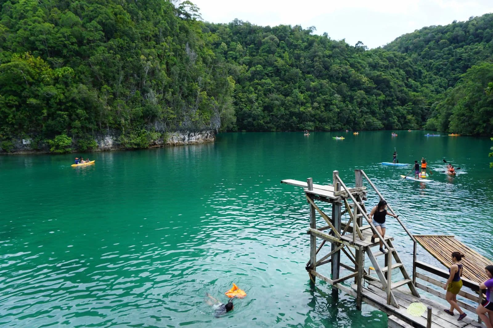 Wooden jump platform above the emerald water of Sugba Lagoon, Del Carmen, Siargao