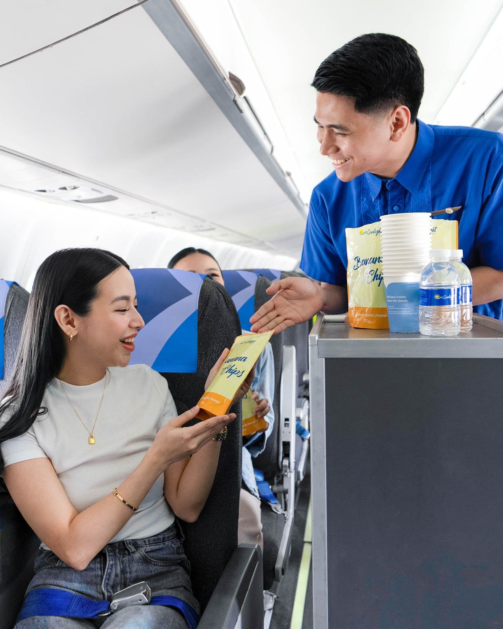 Passenger receiving an inflight snack on a Sunlight Air flight